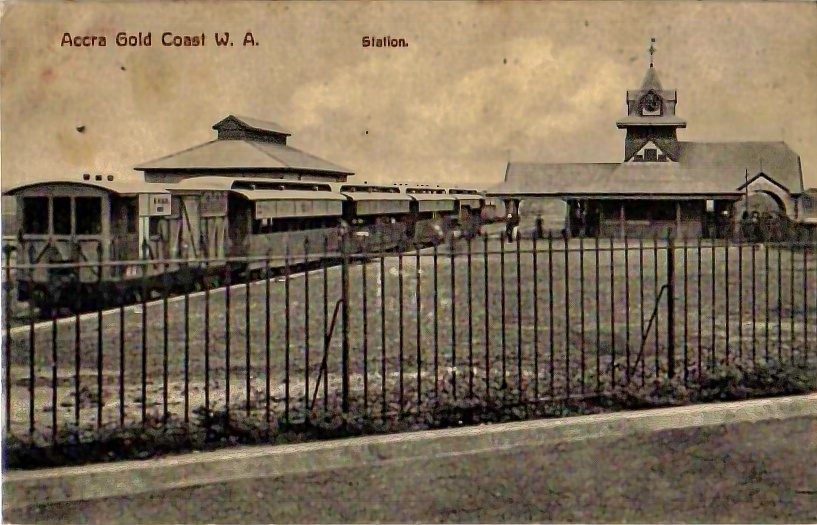 Old photo postcard of the railway station in Accra, Gold Coast, with a train and carriages, early twentieth century